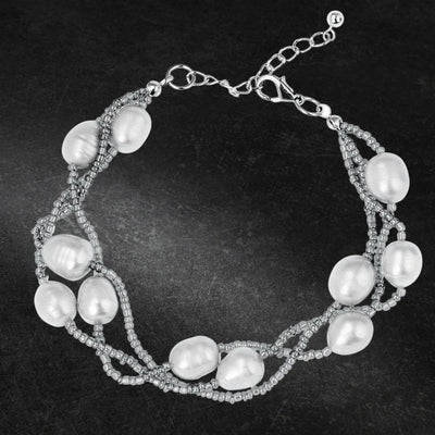 Dove Silver Pearl Bracelet featuring delicate gems and intertwined silver beads, designed for a refined and elegant female jewelry collection.