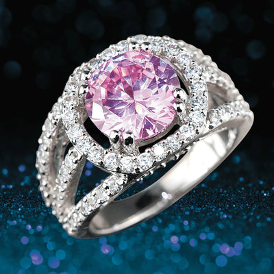 Blush Halo Ring featuring a sterling silver band with rhodium plating, showcasing a large pink centerpiece stone surrounded by sparkling clear accents in an elegant design for women.