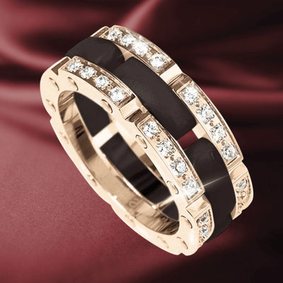 Java Ceramic Perfection Ring (Black) featuring stainless steel with rose gold plating, accented by sparkling crystals, designed for women, displayed on a burgundy fabric background.