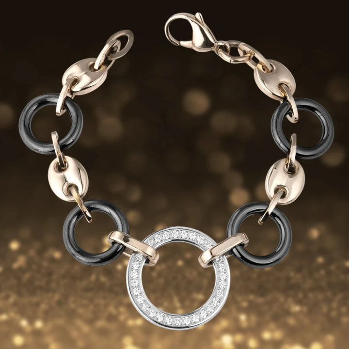Java Ceramic Halo Bracelet featuring stainless steel and rose gold plating with glossy black ceramic links and a central circular pendant adorned with sparkling crystals.