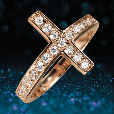 Reclining Cross Gold Ring in sterling silver with gold plating, featuring a cross design adorned with sparkling clear stones, designed for women’s jewelry collection.