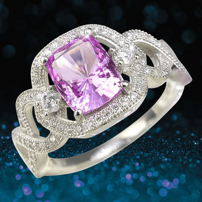 Lola Ring featuring a sterling silver band plated in rhodium, elegantly set with a rectangular pink gemstone and intricate detailing for a refined female jewelry piece.