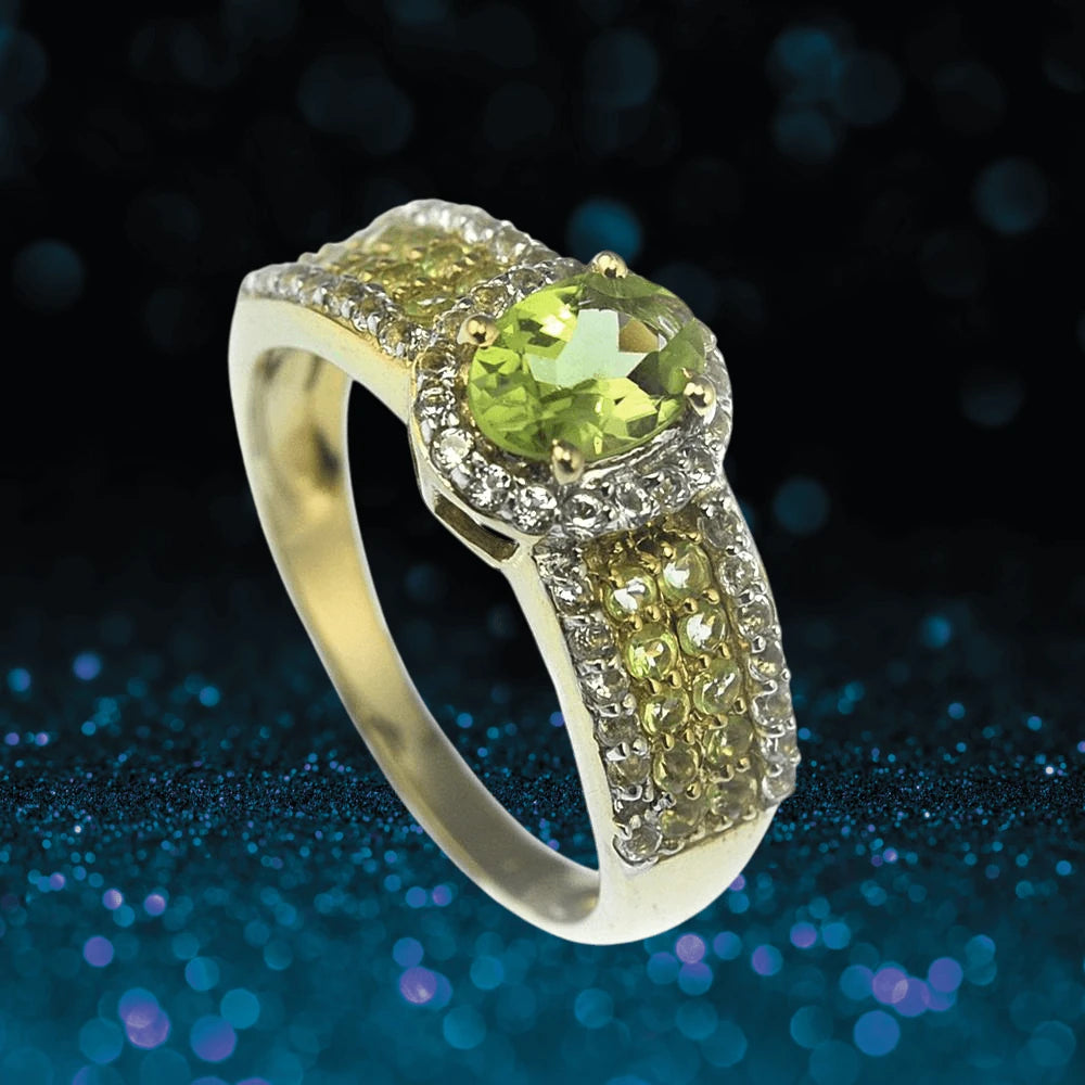 Peridot Eden Ring featuring a sterling silver band with gold plating, designed for women, showcasing a vibrant green peridot center stone surrounded by smaller sparkling accents.