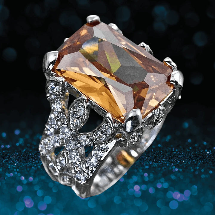 Honeysuckle Ring featuring a large rectangular amber gemstone set in sterling silver with rhodium plating, embellished with intricate floral-inspired detailing and sparkling accents.
