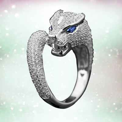 Panther Rhodium Ring in sterling silver with rhodium plating, featuring a detailed panther head design accented by blue gemstone eyes and sparkling stones.