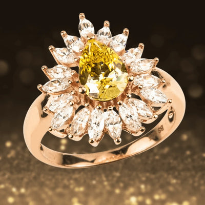 Canary Pear Ring featuring a pear-shaped yellow gemstone surrounded by marquise-cut clear stones, set in sterling silver with gold plating, designed for women’s jewelry.
