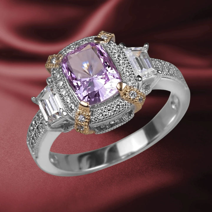 Dahlia Blossom Ring featuring a two-tone sterling silver band with a central purple gemstone flanked by two clear rectangular stones, detailed with surrounding small pavé accents.