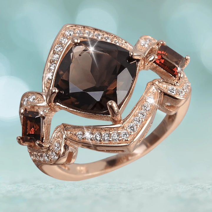 Cocoa Santana Ring featuring a large smoky gemstone centerpiece surrounded by smaller clear stones set in sterling silver with rose gold plating, designed for women’s jewelry collections.