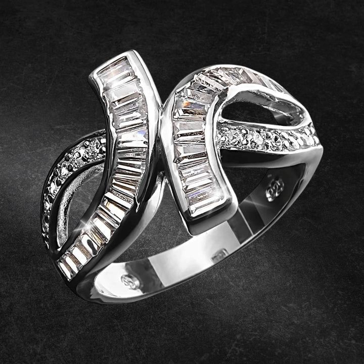 Baguette Twist Ring Rhodium crafted from sterling silver features an elegant twisted design adorned with baguette and round cut stones, enhancing feminine jewelry collections.