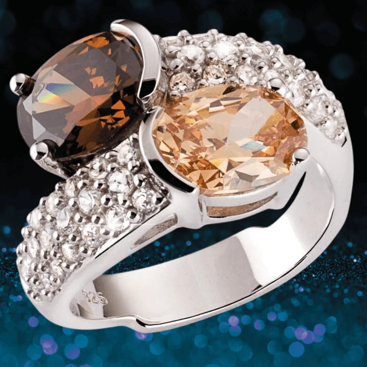 Sterling silver DS You And Me Ring for female with two large oval gemstones, one smoky brown and one champagne, accented by small clear crystals along the band.