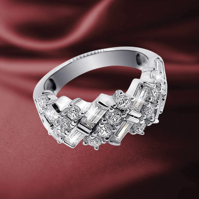 Sterling silver Ascot Ring for female with rhodium plating, featuring a geometric design adorned with sparkling clear gemstones on a smooth band against a silky red background.
