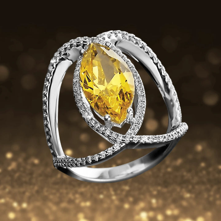 Curvela Marquise Ring featuring a sterling silver band with rhodium plating, adorned with a large marquise-cut yellow gemstone and sparkling surrounding stones, designed for females.