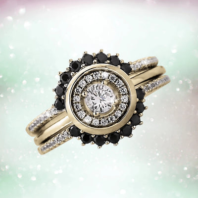 Close-up of a Trio Halo Ring featuring a sterling silver base with gold plating, adorned with sparkling white and black gemstones, designed for women’s jewelry.