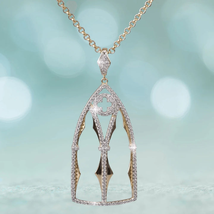Abbey Pendant featuring a sterling silver and gold design with intricate details and sparkling accents, suspended from a gold chain, crafted for women’s jewelry collections.