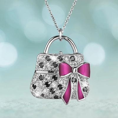 Sterling silver Passarela Bag pendant necklace with rhodium plating, featuring black accents and a vibrant pink bow, designed for women jewelry collection.