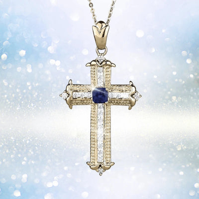 Sapphira Cross Pendant featuring a sterling silver cross plated in gold with a central blue sapphire gemstone, designed as a women's elegant jewelry necklace pendant.