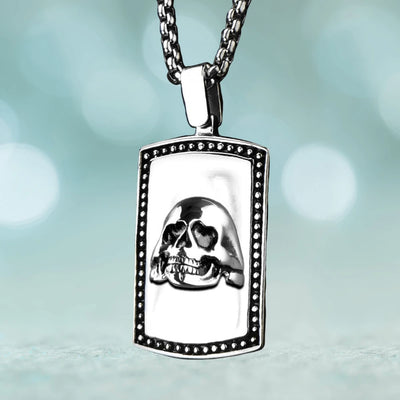 Skull Pendant featuring a detailed skull design on a rectangular stainless steel plate with beaded edge, suspended from a matching polished chain for men’s jewelry.