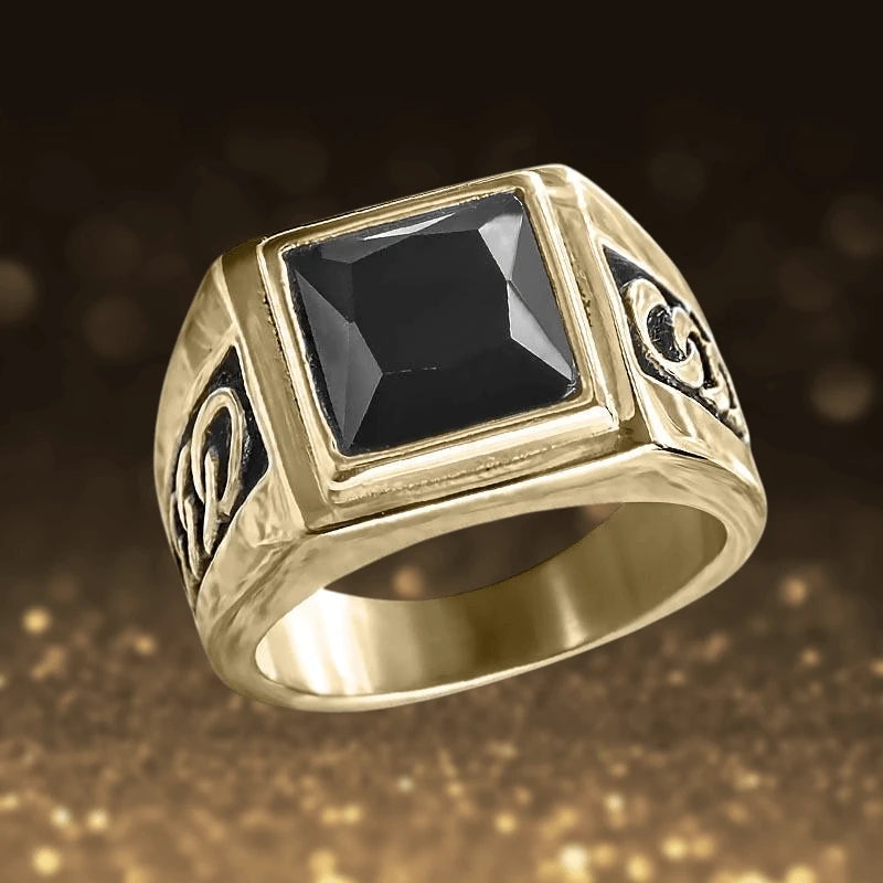 Collins Noir Ring featuring a gold-plated stainless steel band with intricate black detailing and a prominent square black stone centerpiece for men’s jewelry.