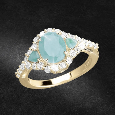 Sakota Emerald Ring featuring a sterling silver band with gold plating, showcasing a central emerald stone surrounded by sparkling clear stones, designed for women.