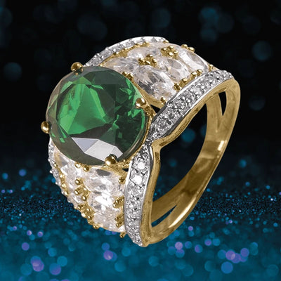 Fairfield Ring featuring a sterling silver band with gold plating, adorned with a large green gemstone centerpiece and sparkling clear stones, designed for women’s jewelry.