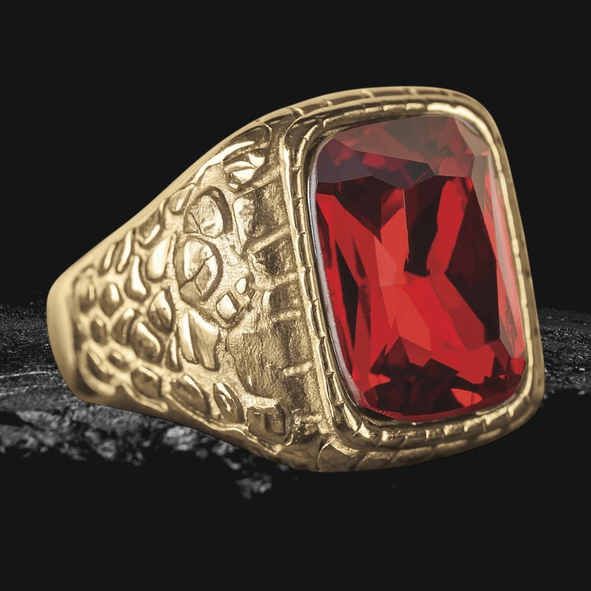 Serpenta Red Ring featuring a bold rectangular red gemstone set in gold-plated stainless steel with a textured serpentine design, crafted for men’s jewelry collections.
