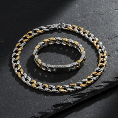 Two silver and gold chain necklaces on a dark surface. Curb Vine Men's Set by Daniel Steiger