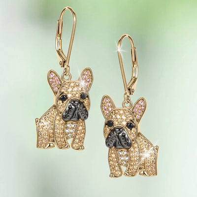 Forever Frenchie Earrings featuring gold French bulldog drop earrings with crystal details pink inner ears and black enamel noses on a soft green background