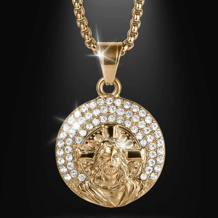 Faith And Promise Pendant with a gold tone round medallion featuring a detailed Jesus portrait surrounded by sparkling clear stones on a chain