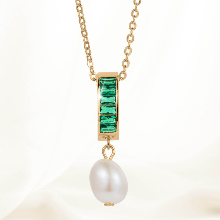 Pearl Radiance Pendant featuring a gold chain with a rectangular gold setting adorned with four green gemstones and a single white pearl drop pendant.