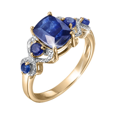 Elara Sapphire Ring featuring a large blue sapphire center stone with smaller sapphires and sparkling diamond accents in a polished gold setting