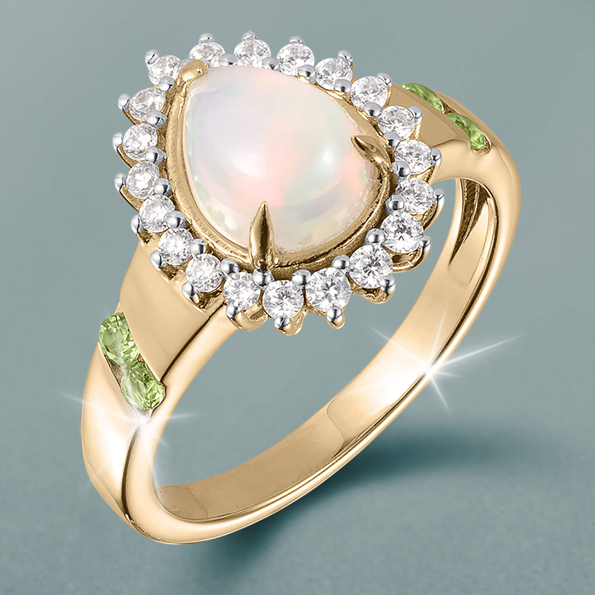 Opal Dew Drop Ring with a luminous opal center, sparkling diamond halo, gold band, and green gemstone accents Up To 75% Off Retail