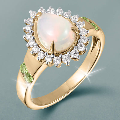 Opal Dew Drop Ring with a luminous opal center, sparkling diamond halo, gold band, and green gemstone accents Up To 75% Off Retail