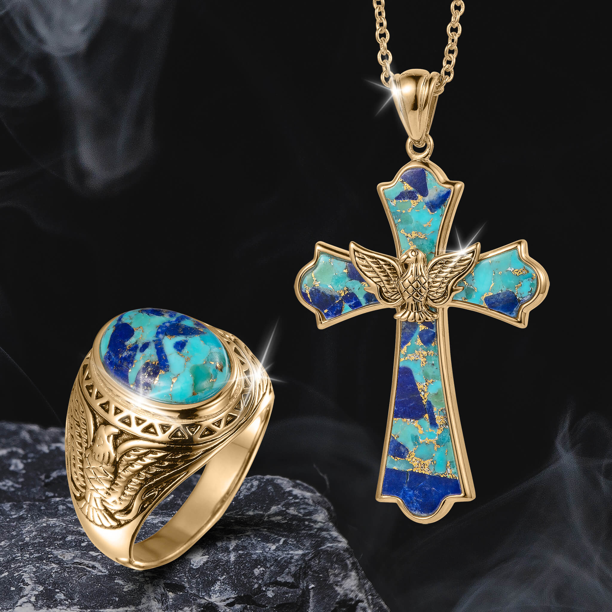Gold ring with blue and turquoise stone beside a gold cross pendant with turquoise inlay and a detailed eagle, both from the Wings Of Freedom Collection displayed on dark textured surface.
