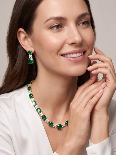 Freya Collection green gemstone necklace and matching drop earrings worn by a smiling woman showcasing elegant jewelry Up To 75% Off Retail