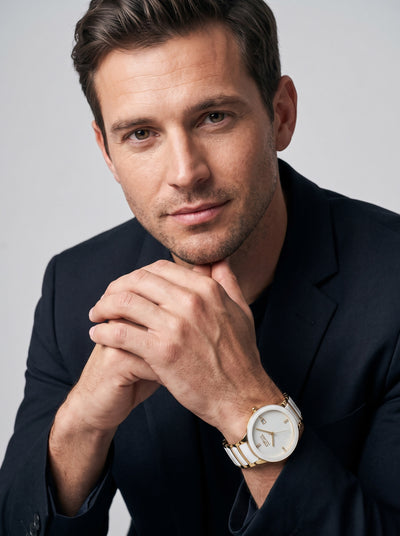 Ceramic Blanc Men's Watch worn by a man in a navy blazer with a white ceramic bracelet and gold accents for a refined luxury look