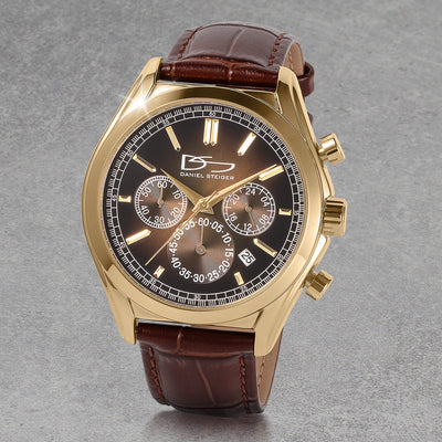 Vicerory Watch & Bracelet Box Set featuring a gold tone chronograph watch with black dial, luminous markers, subdials, date window, and brown leather strap