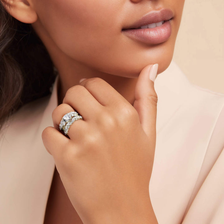 Close-up of a woman wearing the Savoy Bridal Ring in sterling silver with gold plating, showcasing its elegant design and sparkling gemstones on her hand.