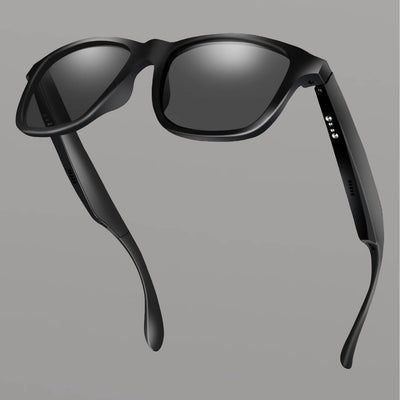 Black smart sunglasses with reflective lenses on a gray background. Reactive Smart Sunglasses
