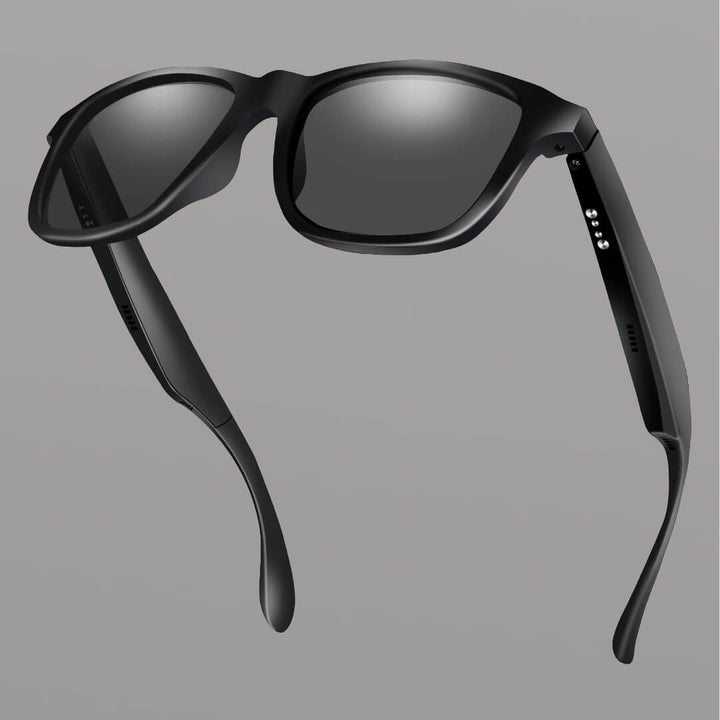 Black smart sunglasses with reflective lenses on a gray background. Reactive Smart Sunglasses
