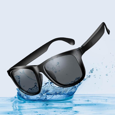 Black smart sunglasses with water droplets on a blue water background. Reactive Smart Sunglasses
