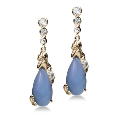 Mermaid Lagoon Earrings featuring gold-plated sterling silver with blue teardrop stones and sparkling clear crystals, designed for women’s elegant jewelry collections.