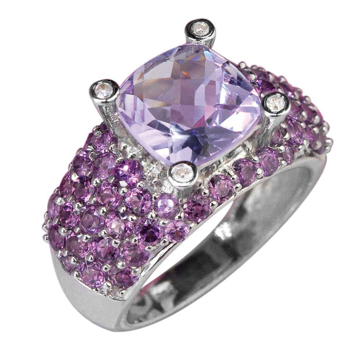 Antoinette Ring featuring a sterling silver band adorned with purple gemstones and a large cushion-cut lavender center stone, designed for female jewelry lovers.