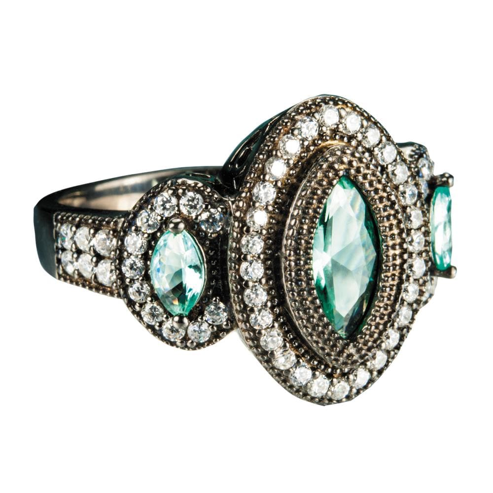 Black Orchid Ring featuring sterling silver with an intricate design showcasing oval blue stones surrounded by sparkling clear crystals, elegant female jewelry piece.