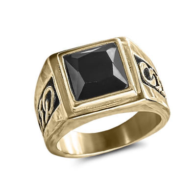 Collins Noir Ring featuring a bold black square stone set in a gold-plated stainless steel band with intricate male design details, a sophisticated jewelry piece.