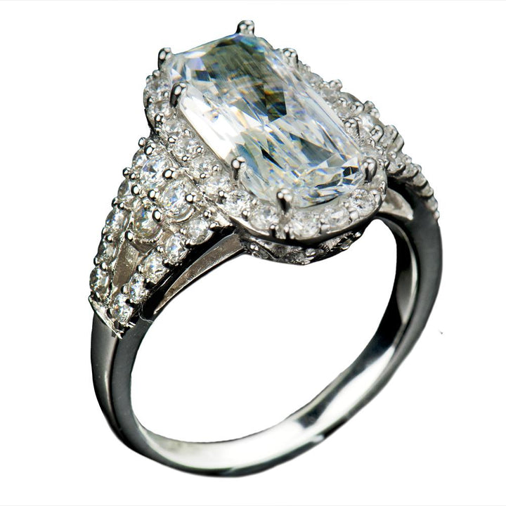 Glacier Rhodium Ring featuring a sterling silver band plated with rhodium, adorned with a large rectangular clear stone surrounded by smaller sparkling gemstones, designed for women.