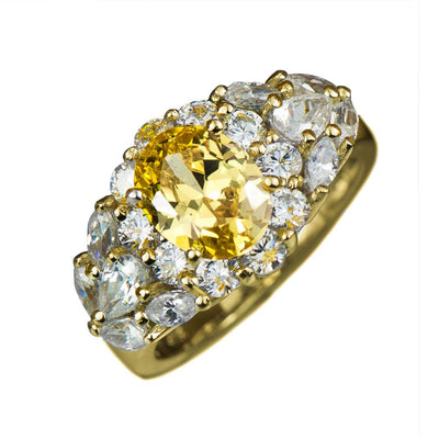 Gold Canaria Ring featuring a sterling silver band plated in gold, adorned with a central yellow gemstone surrounded by multiple clear sparkling stones, designed for women’s jewelry.