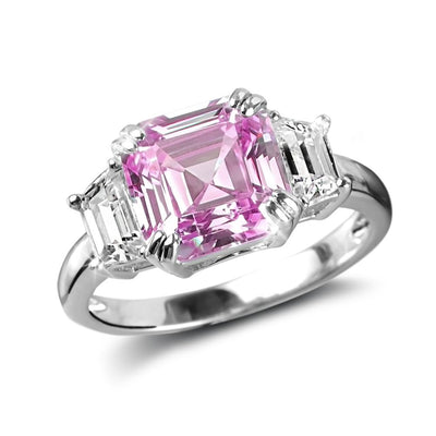 Asscher Pretty In Pink Ring featuring a sterling silver band plated with rhodium, showcasing a large pink Asscher-cut center stone flanked by two clear rectangular gemstones.