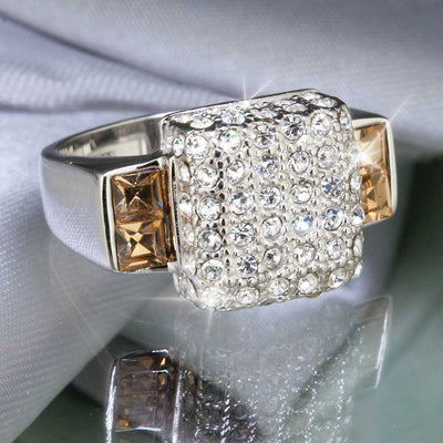 Trellis Ring crafted in sterling silver featuring a square cluster of clear sparkling stones with two rectangular champagne-colored stones on each side, elegant female jewelry.