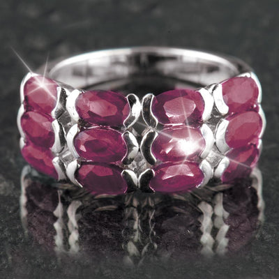 Ruby Band Ring featuring multiple oval-shaped red ruby gemstones set in sterling silver with rhodium plating, designed for women’s elegant jewelry collections.