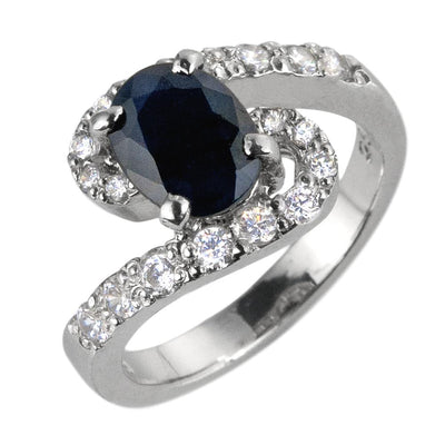 Sterling silver Sapphire Meander Ring for female with rhodium plating, featuring an oval deep blue sapphire centerpiece surrounded by sparkling clear stones in a winding design.